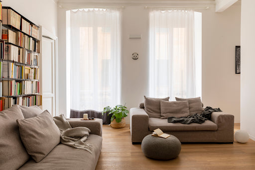 indoor hardwood floor with sofa and bookshelf